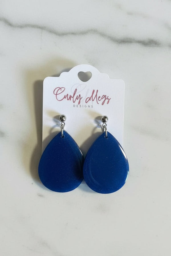 Curly Megs Designs glossy blue teardrop dangle earrings with high-shine finish.