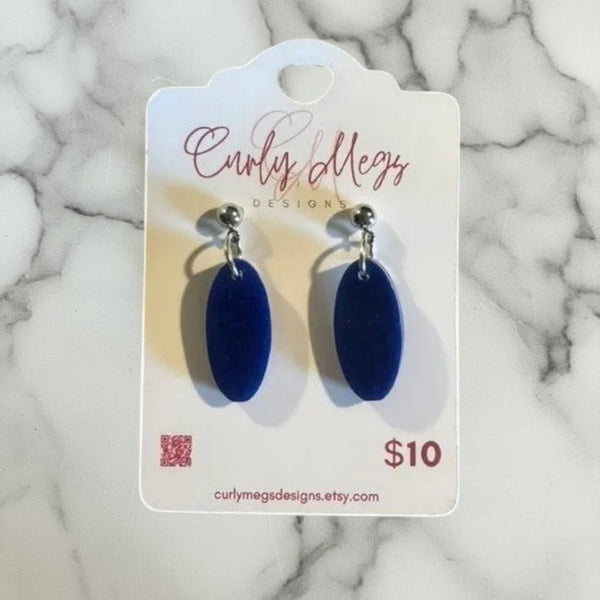 Curly Megs Designs navy blue oval dangle earrings. Lightweight, matte material with a modern, minimalist design.