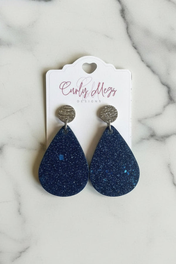 Curly Megs Designs navy resin teardrop glitter earrings with textured silver studs.