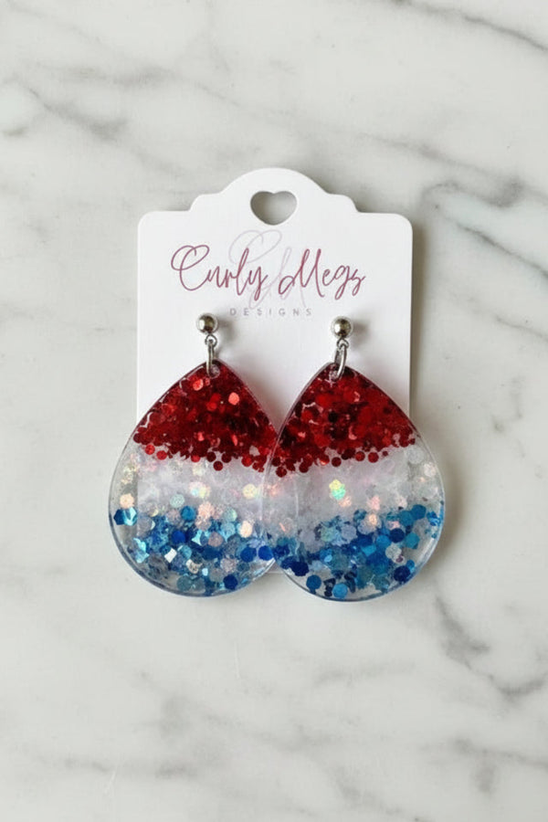 Curly Megs Designs patriotic teardrop resin earrings filled with red, white, and blue glitter.